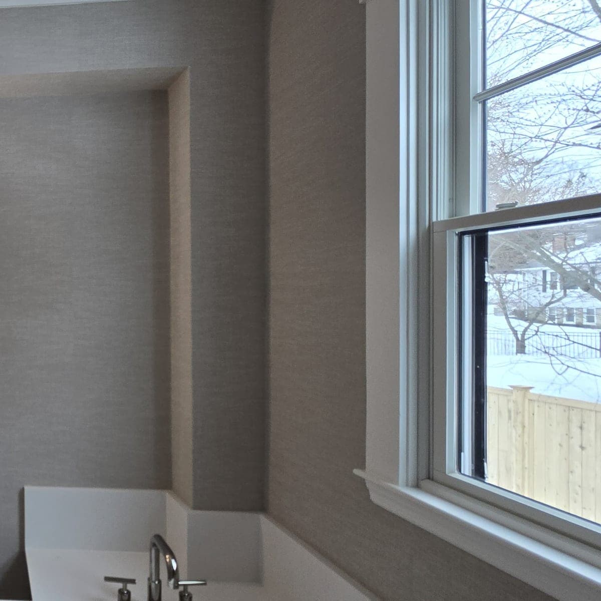 The grasscloth bathroom from the other side: sconces, vanity and the soaking tub